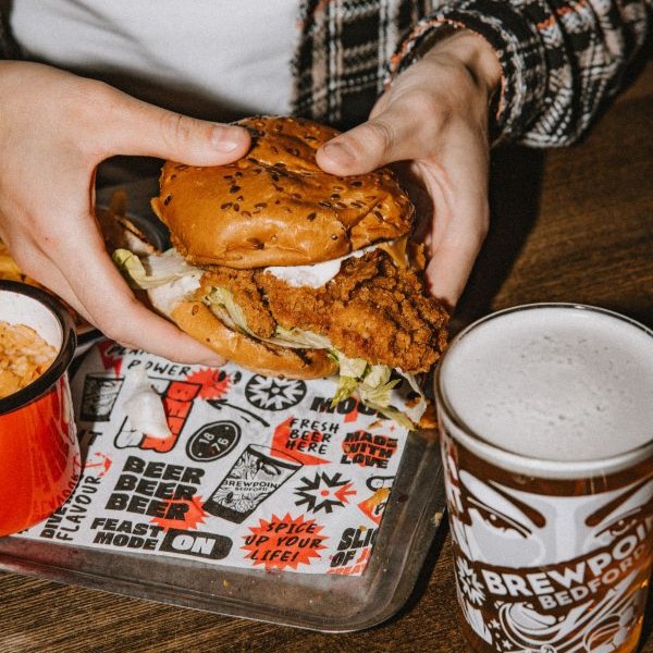 Fully loaded crispy chicken burger paired with a pint